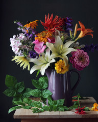 Bouquet of garden flowers in a jug. Still life. © Masquerade