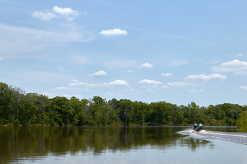 Boat on calm scenic river on a bright sunny day