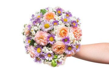 A beautiful wedding bouquet of flowers roses, chamomile and decorative yarrow is in the hands of a girl. Love and relationships. Flora. Spring, summer