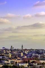 Obraz premium Jaffa urban skyline rooftops at sunset with church steeple 