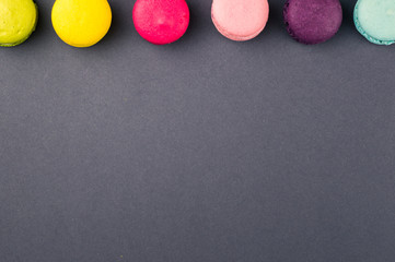Colourful french macaroons on the grey background, Top view