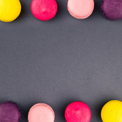 Colourful french macaroons on the grey background, Top view. Square