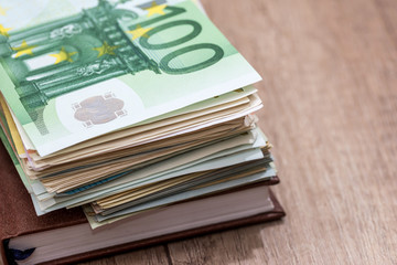 euro, notepad and on desk. close up