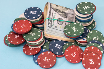 dollar and poker chips on blue background