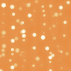Orange textured background with light bokehs.