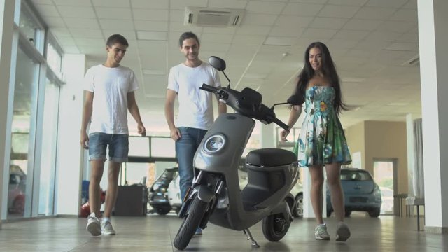 Young people are choosing the scooter in the car dealership