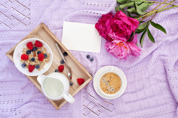 Breakfast with coffee, granola, berries and milk