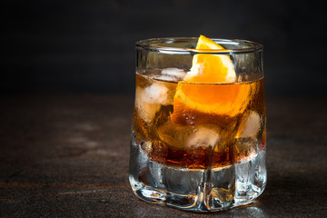 Negroni cocktail in glass on dark. Strong alcohol cocktail drink.