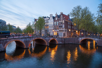 Fototapeta premium Beautiful night in Amsterdam. Night illumination of buildings and boats.