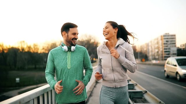 Attractive man and beautiful woman jogging together