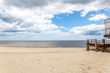 Fototapeta na wymiar Beach with a nice wooden pier on a nice summer day