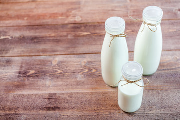 bottles of milk on a wooden rustic table. copy space