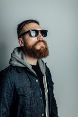 Fototapeta premium man looks off into distance with sunglasses