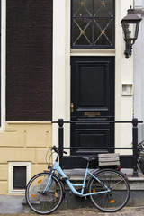 Fototapeta na wymiar Typical Amsterdam's facade with bicycle in front of it, Netherlands