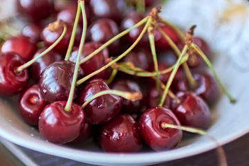 Ripe juicy cherry and cherry in a plate.