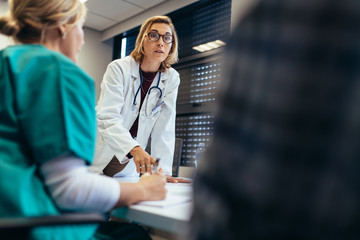 Female doctor briefing her team during meeting