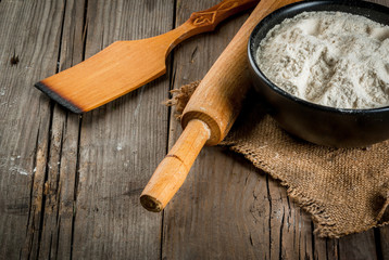 Baking background. Tools and ingredients for baking on the old rustic wooden table. Copy space