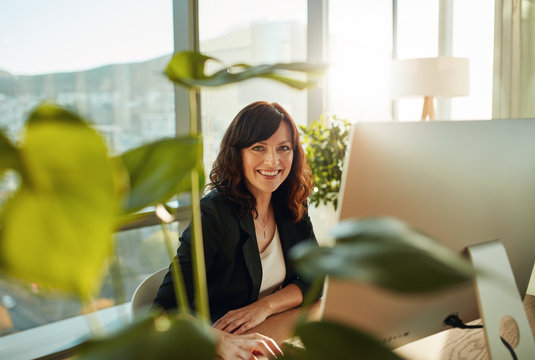 Smiling female designer at her workplace