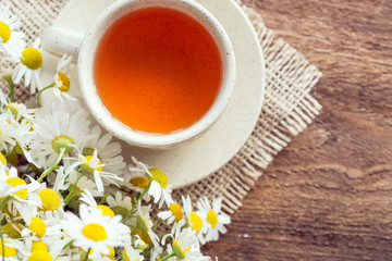 cup of herbal chamomile tea with camomile dry blossoms, dried camomile flowers. doctor treatment and prevention of immune concept, medicine - folk, alternative, complementary, traditional medicine 