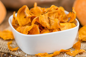 Sweet Potato Chips on wooden background; selective focus