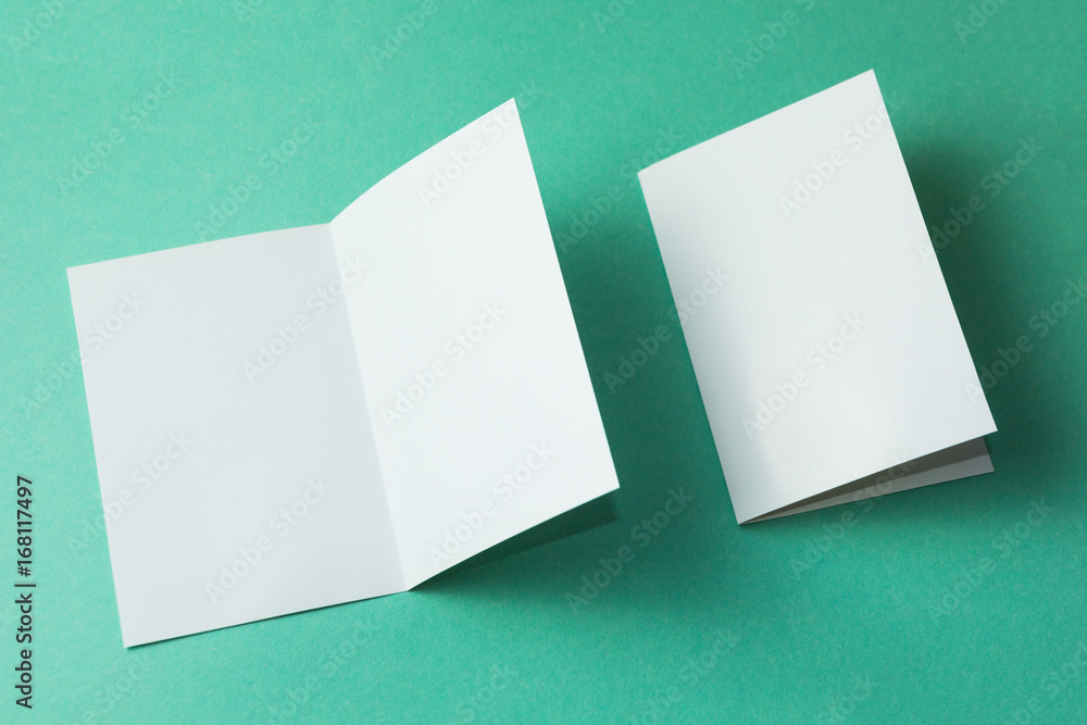 Poster white empty brochure on green background to replace your design. mockup.