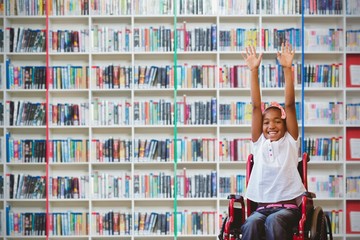 Composite image of girl in wheelchair in school corridor
