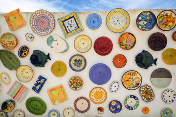 Colourful local pottery at a house wall in the Algarve, Portugal © ah_fotobox
