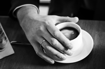 cup of coffee in man's hand