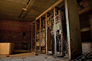 Fototapeta na wymiar Broken electrical cabinets in abandoned factory
