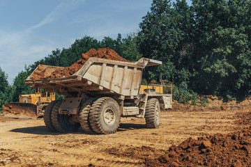 Obraz premium Big industrial truck in a quarry at work