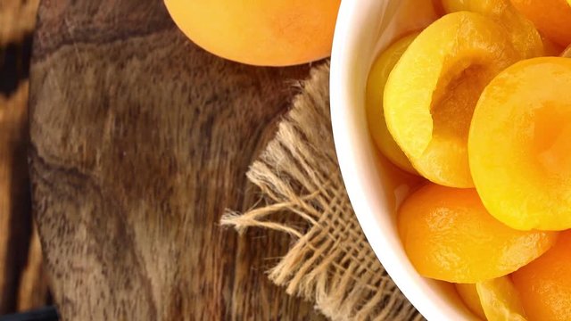 Canned Apricots (rotating on a wooden plate; seamless loopable; 4K)