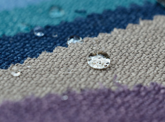 Close up water drop on gunny textile samples. Concept for easy clean, waterproof surfaces