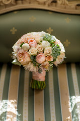 Elegant wedding flower bouqet on texture green sofa