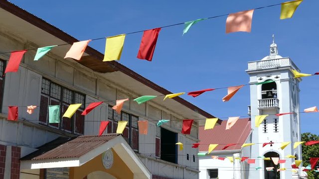 Flags in front of the Santo Nino de Anda Parish Church in anda bohol the Philippines