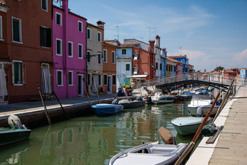 Fototapeta na wymiar The boats and houses on the Burano canal