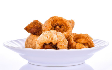 pork scratching in a plate on a white background