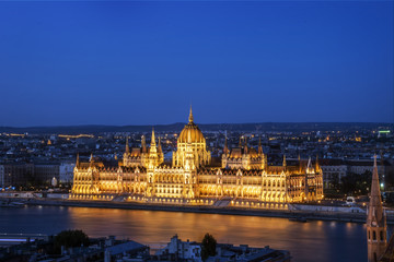 Fototapeta na wymiar Night view of Hungarian Parliament building illuminated next to Danube river