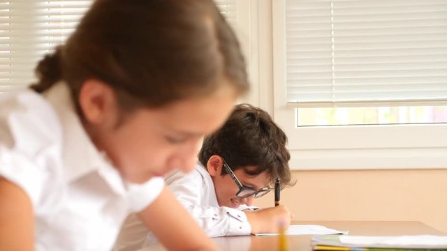 education, people and learning concept - group of students with notebooks writing test at school. 4k. Slow motion