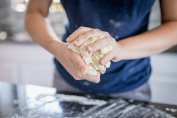 Making dough with flour by female hands, close up