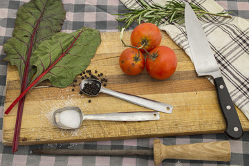 Knife on cutting board with rustic kitchen set for organic meal ideas.