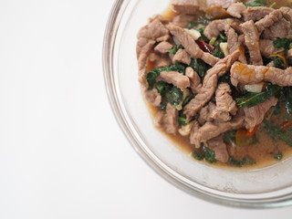 Stir fried Thai local traditional homemade holy basil herb leaf with beef, glass bowl, white background