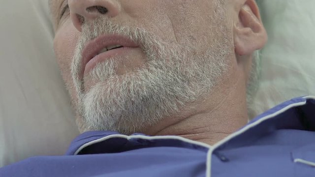 Senior man sleeping with mouth half open and snoring, healthy and sound sleep