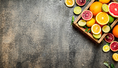 Citrus background. Fresh citrus fruit in an old box.