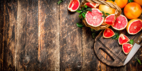 Sliced pieces of grapefruit with a knife.