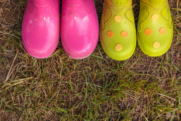 kids bright pink, red, green rubber boots,gardening,boots. Rainy day fashion.Garden Rainy Rubber Shoes.  boots for rainy day. Autumn kids boots concept.
