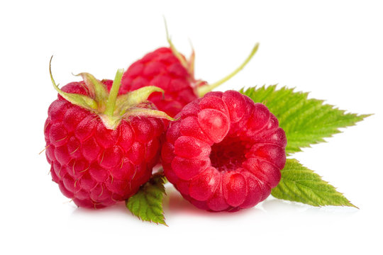 Fresh red raspberries with green leaves isolated on white