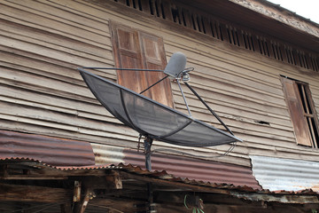 Old wooden house with satellite dishes