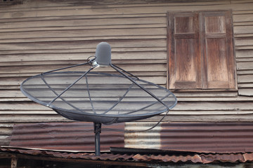 Old wooden house with satellite dishes