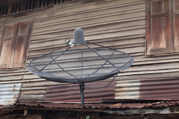 Old wooden house with satellite dishes