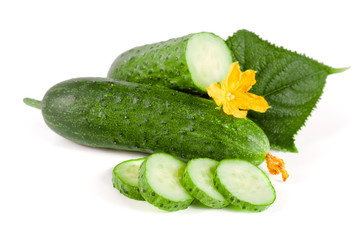 Sliced cucumber with leaf and flower isolated on a white background